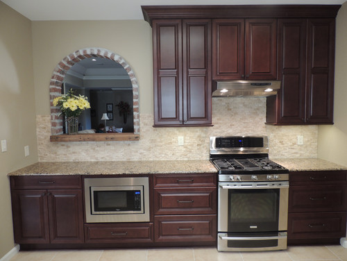 Maple Cabinets with Espresso Stain Cabinets with Cambria Canterbury, Split Face Travertine Backsplash and Porcelain Flooring